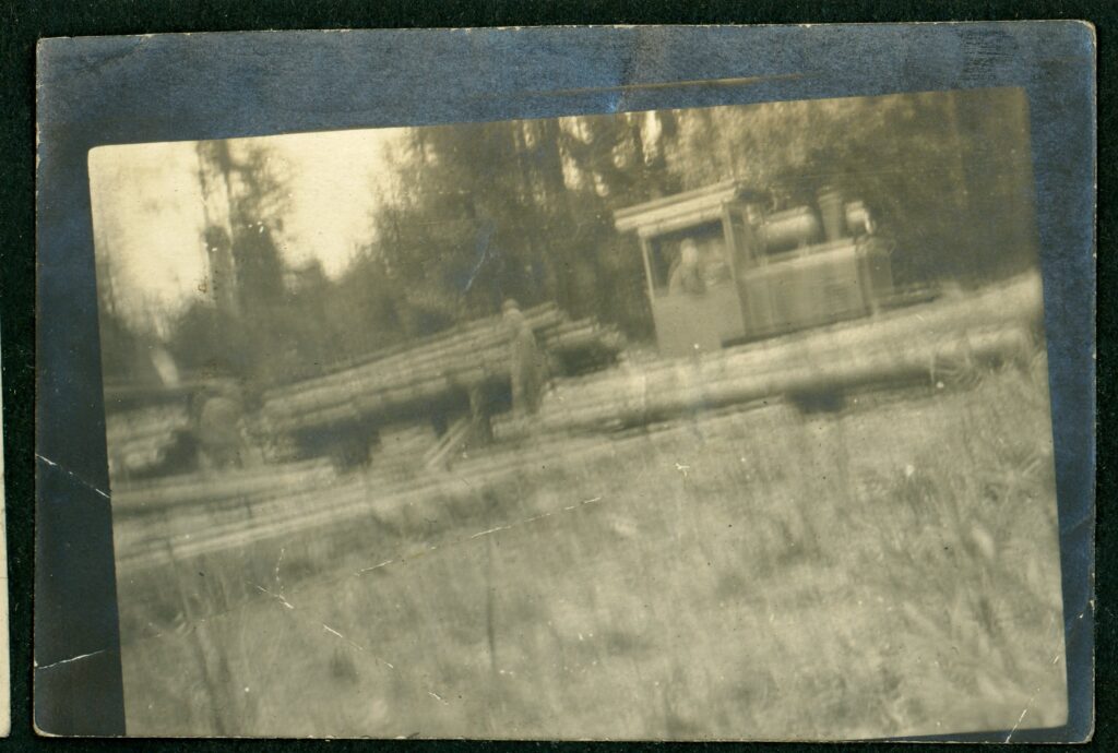 Blurry black and white image showing narrow gauge rail engine