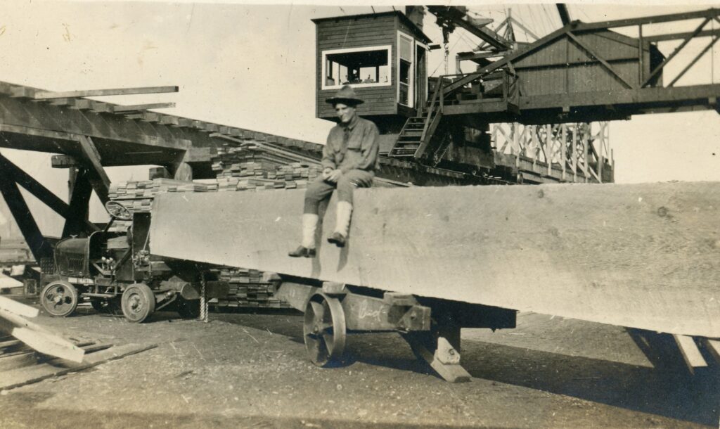 a soldier sits on an unusually large piece of cut lumber